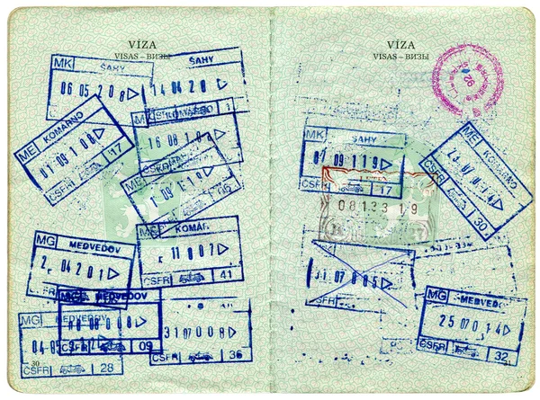 Visa entry and exit stamps in a passport — Stock Photo, Image