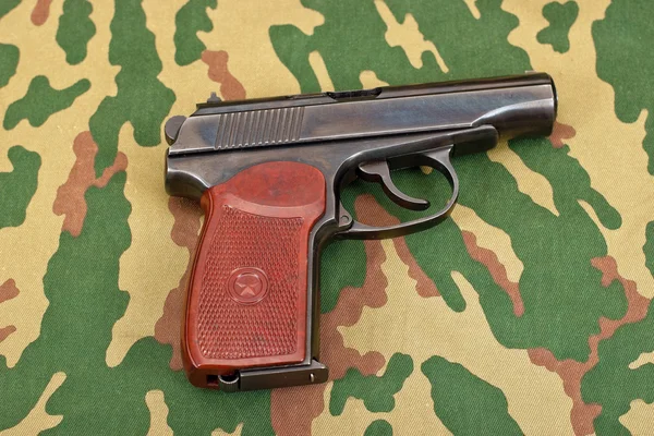 Army handgun on camouflaged background — Stock Photo, Image