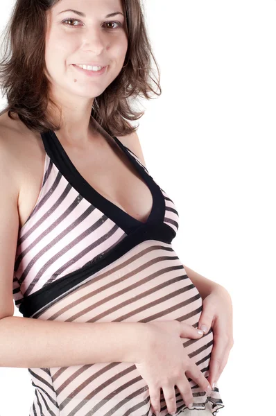 Gravid kvinna händer i form av hjärta tecken — Stockfoto