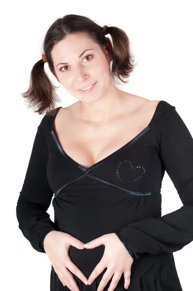 怀孕的女人手中的心标志的形式 — 图库照片