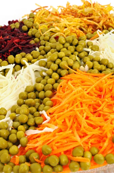 stock image Vegetable salad from a green peas, carrots, a fried potato, a beet and a radish.