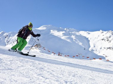 The woman is skiing at a ski resort Solden clipart