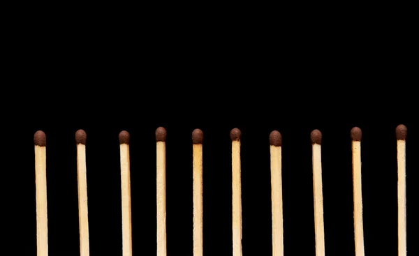 Row of matches on black background — Stock Photo, Image
