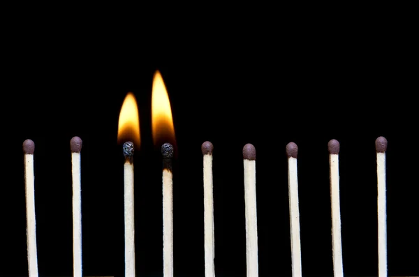 stock image Group of two burn and unburned matches, isolated on black background