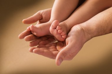 Man's hand and children's foot clipart