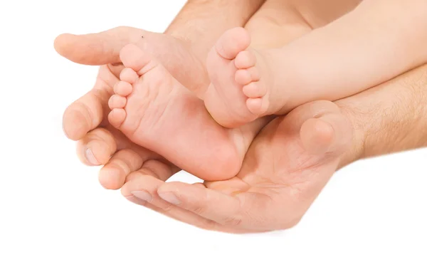 Мужская рука и детская нога — стоковое фото