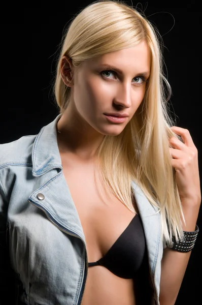 Young woman on a black background — Stock Photo, Image
