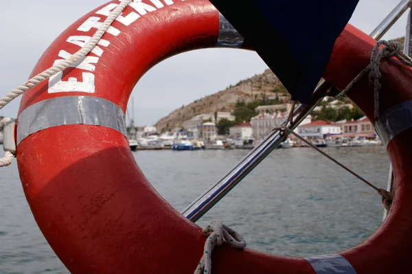 Lifebuoy hanging on board — Stock Photo, Image