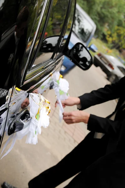Man in a suit decorated with a car — Stock Photo, Image