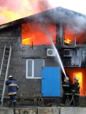 Firefighters extinguish a fire clipart