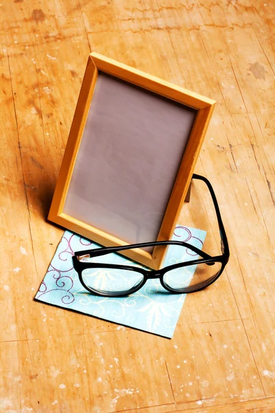 Modern photoframe with glasses — Stock Photo, Image