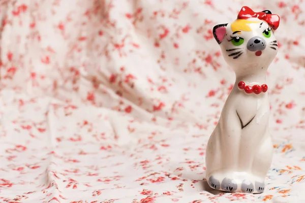 stock image Cat figurine on flower pattern