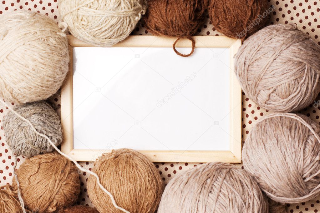 Photoframe with brown balls of yarn