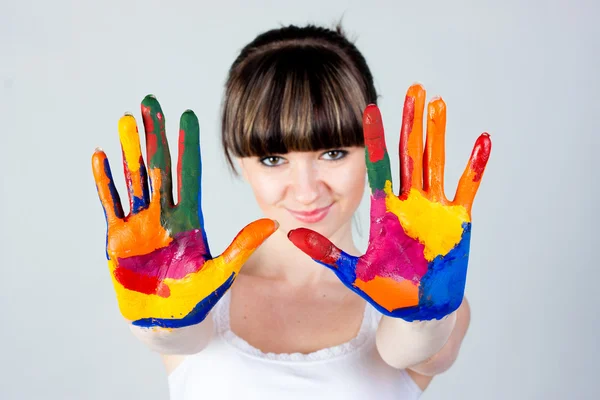 A girl with colored hands — Stock Photo, Image