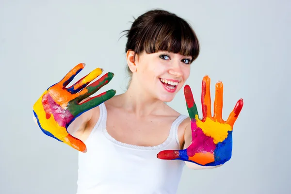 A girl with colored hands — Stock Photo, Image