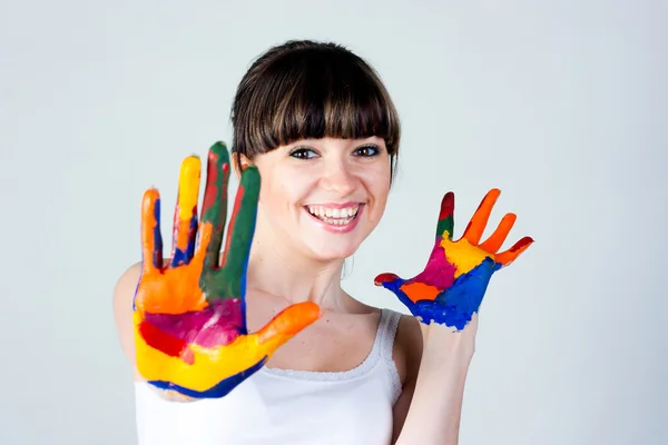 Una chica con manos de colores Imagen de archivo