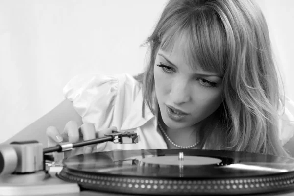 The girl listens to a vinylic disk — Stok fotoğraf