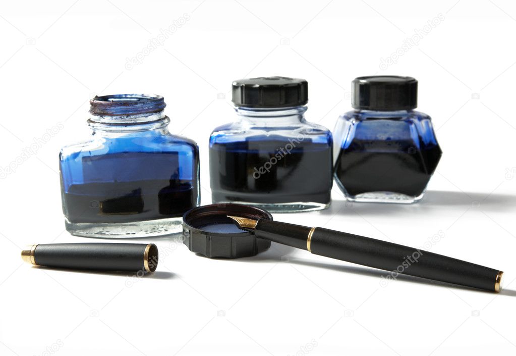 Small bottles with ink and fountain pen on a white background