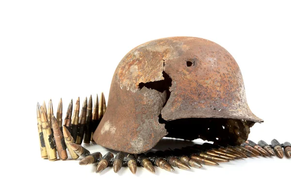 The rusty raked helmet and machine-gun tape — Stock Photo, Image