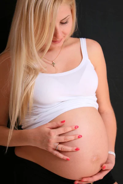 彼女の腹を保持している若い妊娠中のブロンドの女性 — ストック写真