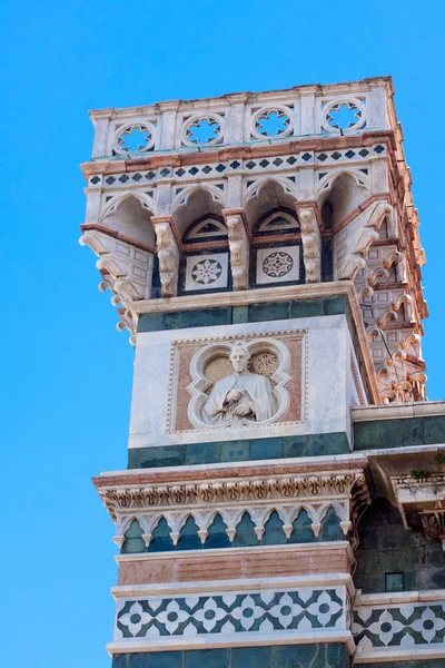 stock image A tower with a statue on the foeef of Basilica di Santa Maria del Fiore