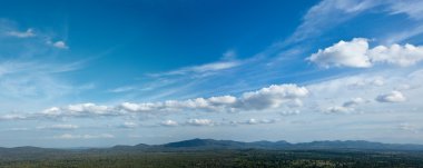 Sky above small mountains clipart