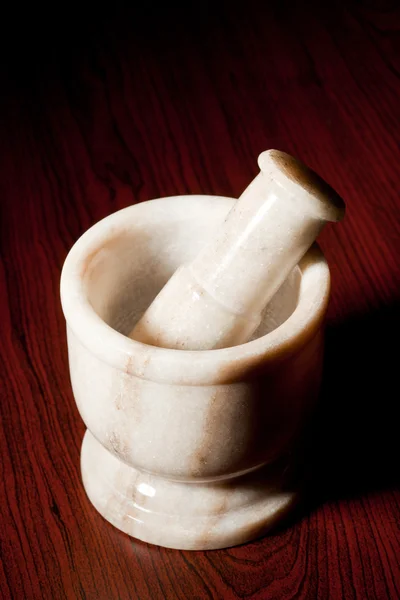 Marble mortar and pestle on dark — Stock Photo, Image