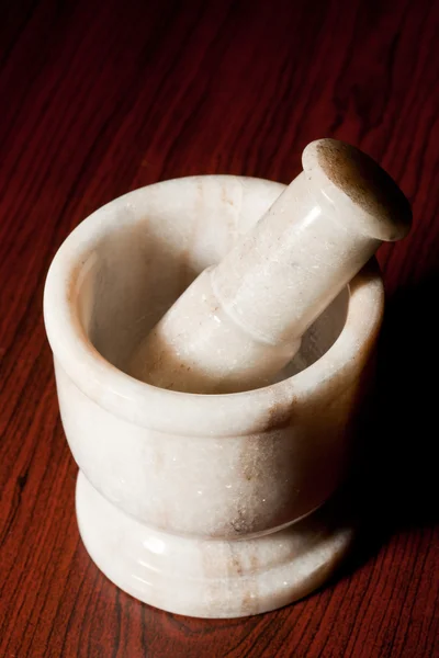 Marble mortar and pestle on dark — Stock Photo, Image