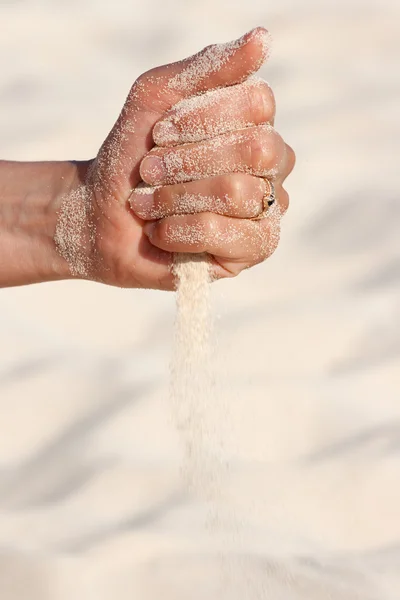 Sand running through hands — Stock Photo, Image