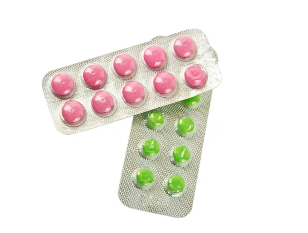 Package with green and pink tablets — Stock Photo, Image