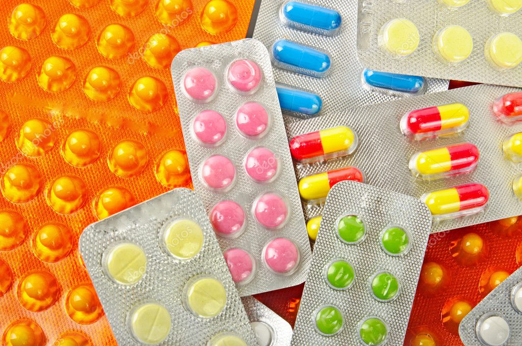 Multicolored medicine pills background — Stock Photo © Roxana #5362369