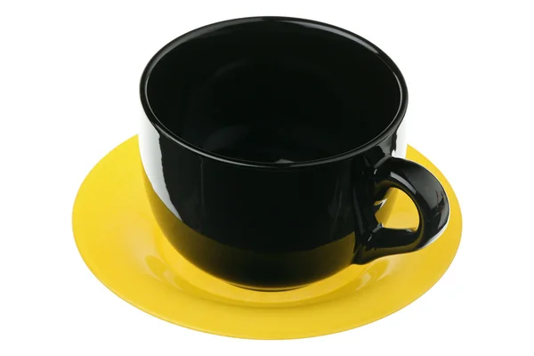 Чорний кухоль на жовтій тарілці — стокове фото