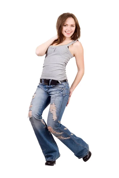 Lachende jonge vrouw in een blauwe spijkerbroek. geïsoleerd — Stockfoto