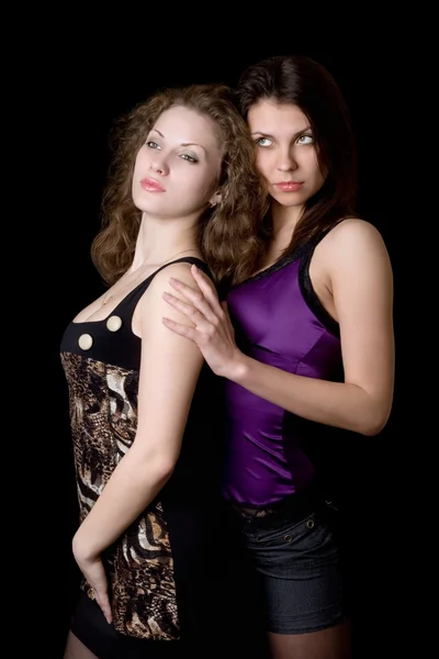 Portrait of the two pretty women. Isolated on black — Stock Photo, Image