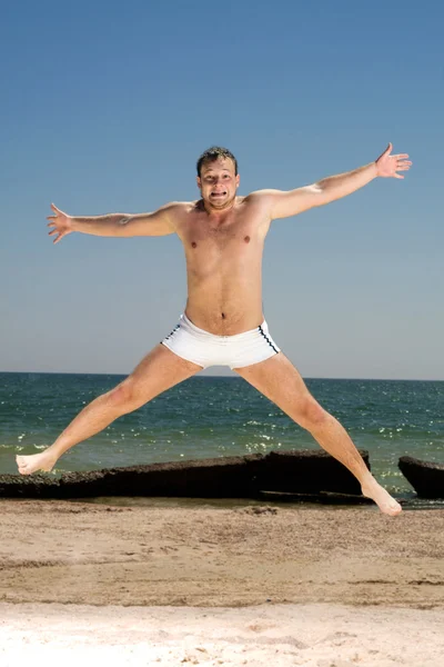 Bizarre Young Man Jumping Beach — Stock Photo, Image