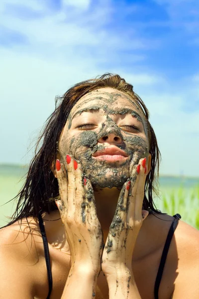 stock image Beautiful young woman taking mud bath outdoors