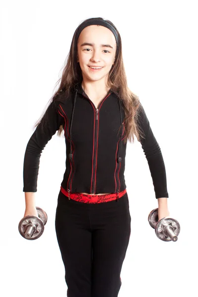 Sportowe dziewczyna robi ćwiczenia fizyczne z hantlami — Zdjęcie stockowe