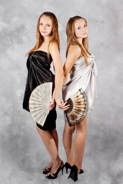 Deux filles sexy avec un ventilateur en capes . — Photo