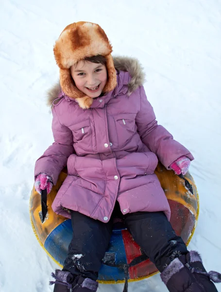 Child Riding Color Covered Inner Tube Snow Cover Hill Speed — Stock Photo, Image