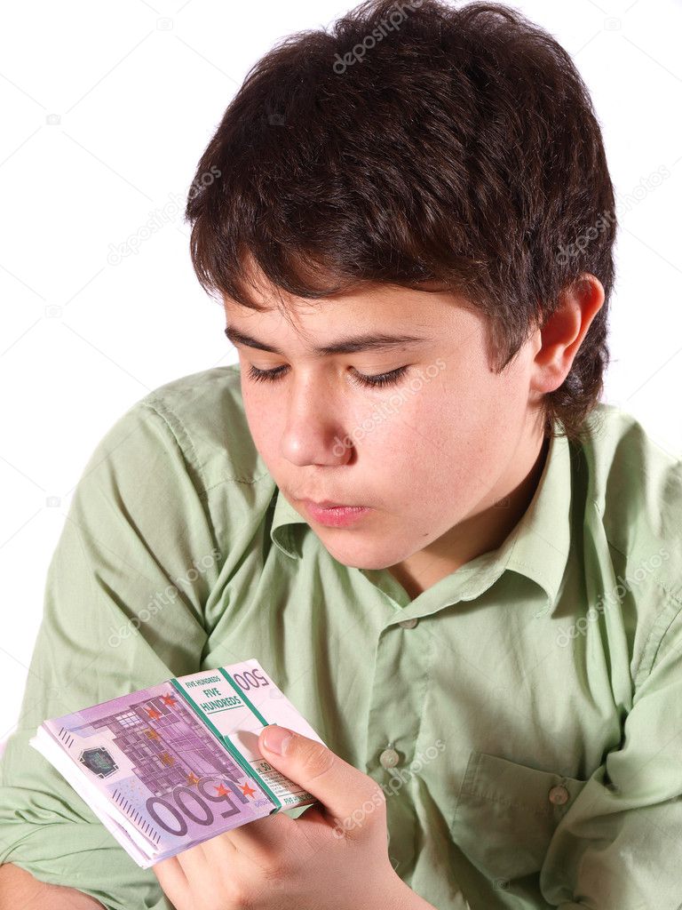 Teen looks at the stack of money. The image on white background.