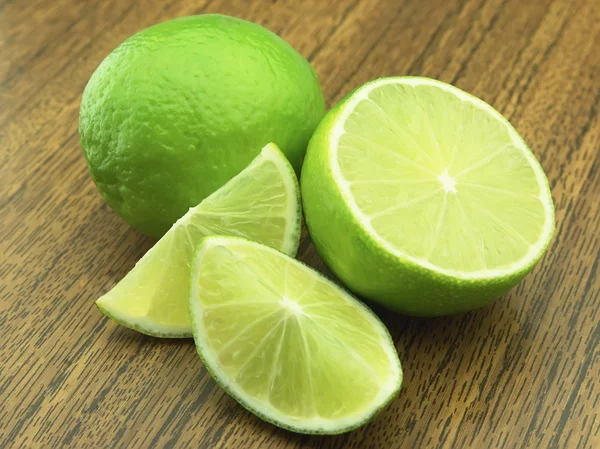 Lime on a wooden table — Stock Photo, Image