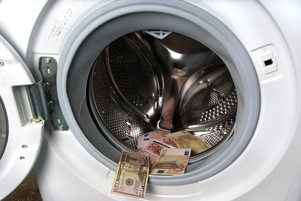 Waschmaschine und Geld Stockbild