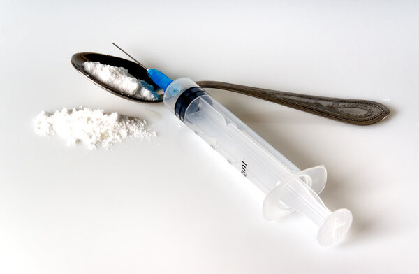syringe and spoon with narcotic