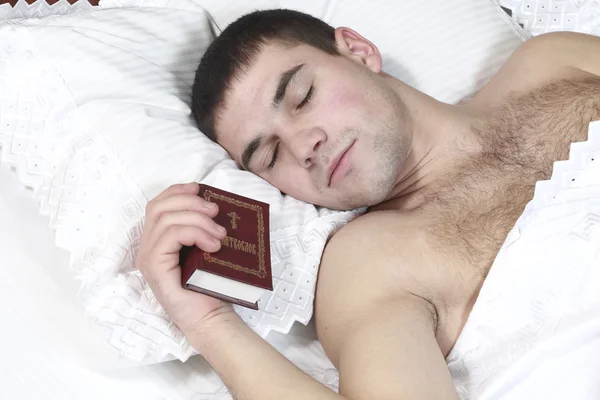 Un joven se quedó dormido con la Biblia en las manos de — Foto de Stock