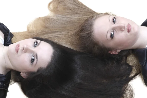 Two girls lie with her hair — Stock Photo, Image
