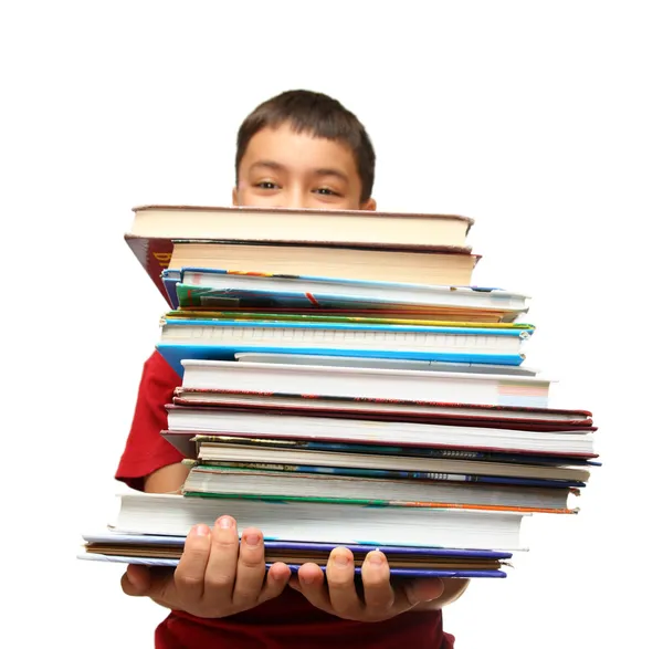 Азиатский мальчик со стопкой книг — стоковое фото