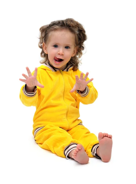 Fun little girl in yellow sitting — Stock Photo, Image