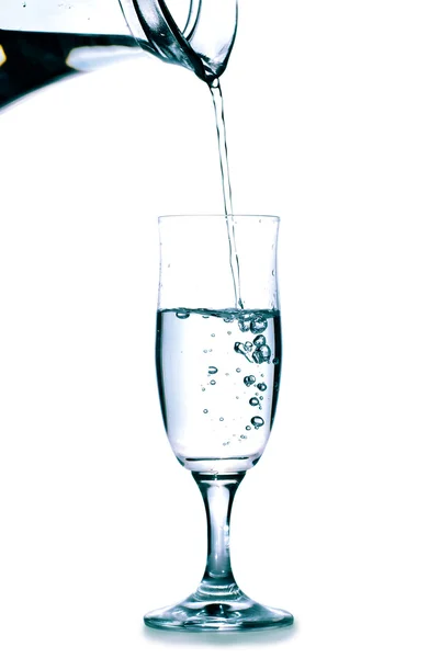 Glass with water and jug — Stock Photo, Image