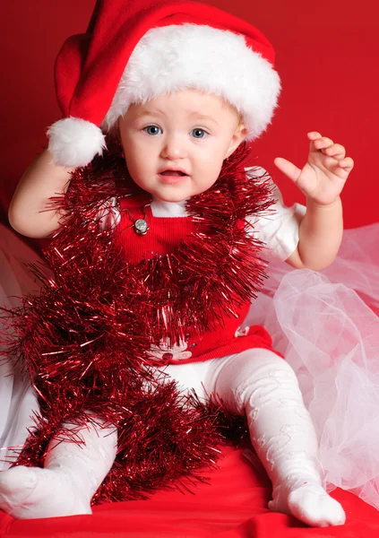 Girl santa on red cloth — Stock Photo, Image