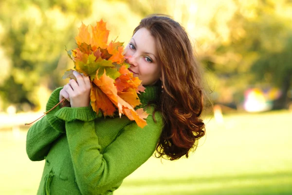 Woman with maple leaves — Stock Photo, Image